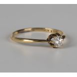 A gold ring, claw set with a cushion cut diamond, detailed '18ct', ring size approx Q1/2, with a