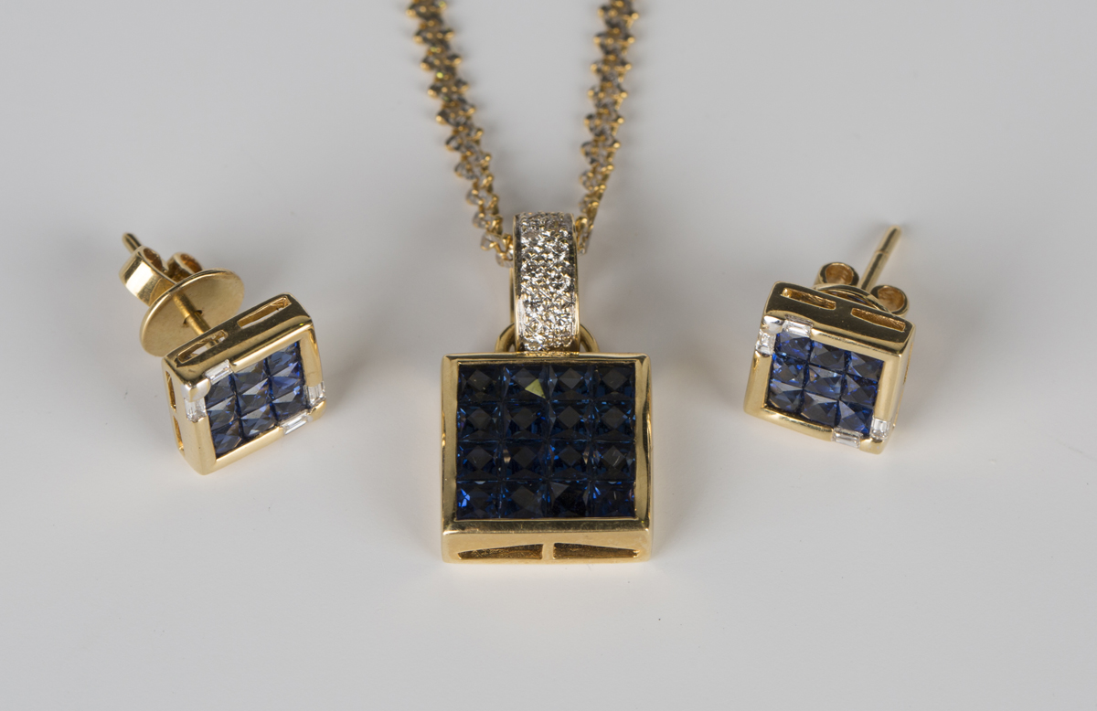 A gold, sapphire and diamond pendant of square form, mounted with sixteen square cut sapphires and a