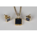 A gold, sapphire and diamond pendant of square form, mounted with sixteen square cut sapphires and a