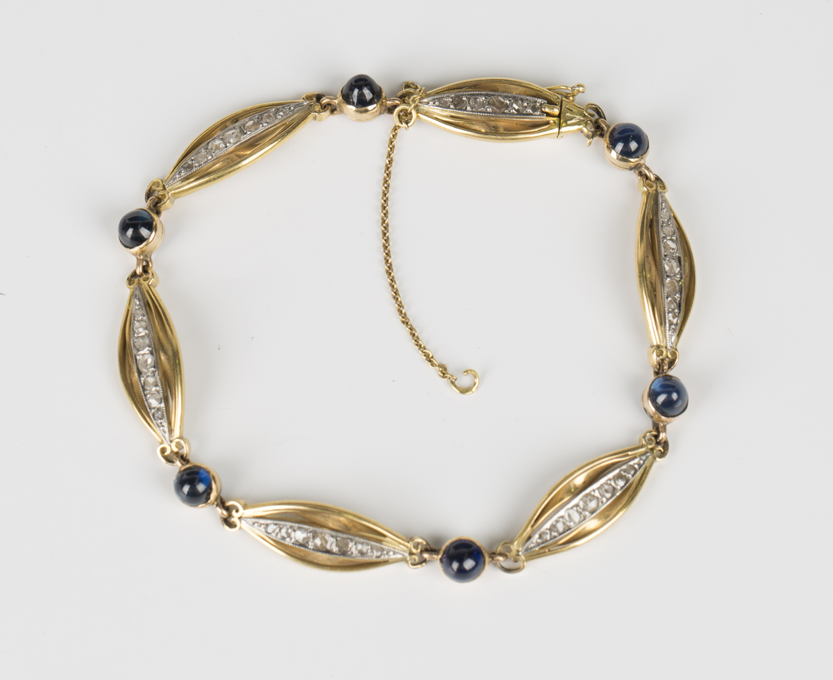 A French gold, platinum, cabochon sapphire and diamond bracelet, formed as a row of six oval