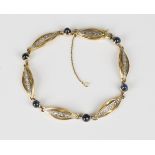 A French gold, platinum, cabochon sapphire and diamond bracelet, formed as a row of six oval
