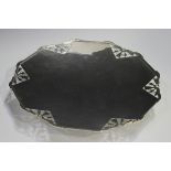 An Art Deco silver footed dish of twelve-sided outline with pierced geometric panels, on a flared