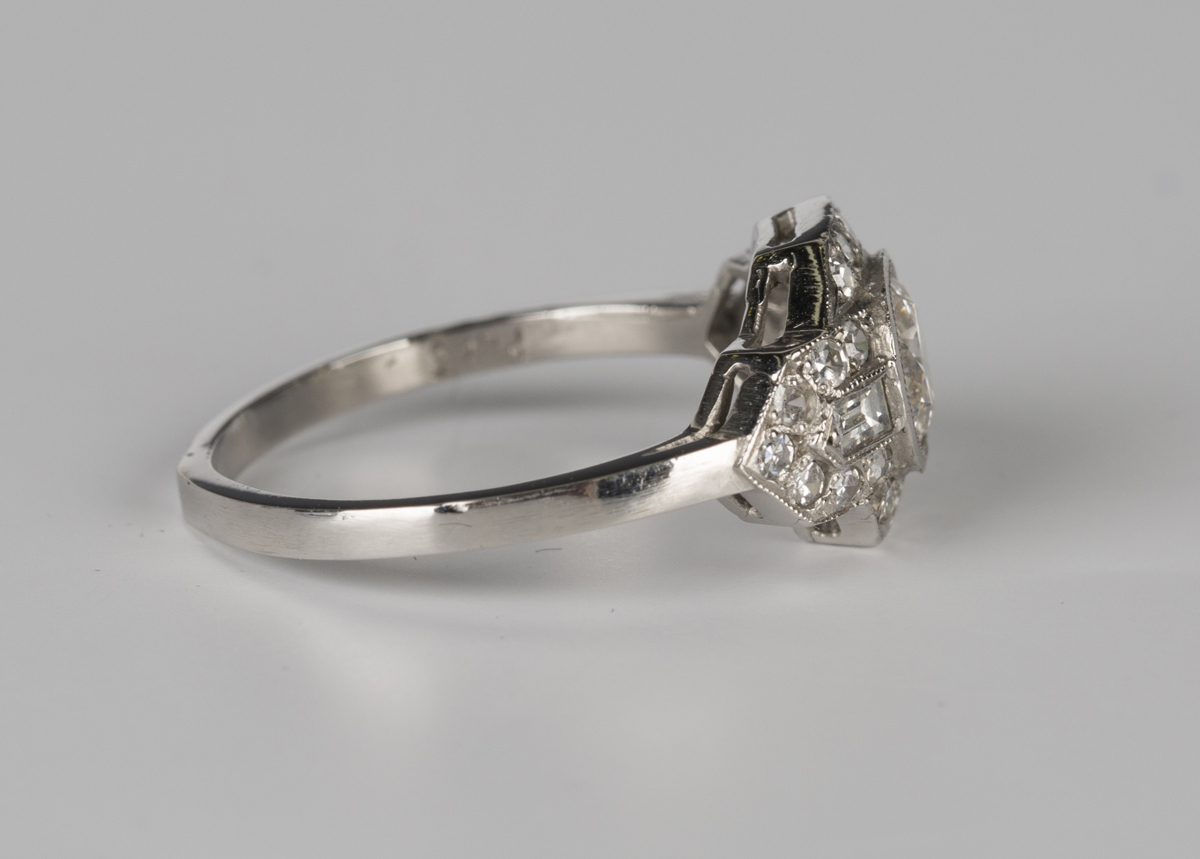 A platinum and diamond ring, collet set with the principal circular cut diamond in a geometric - Image 3 of 4