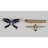 A gold, diamond and blue enamelled brooch, designed as a tied ribbon bow, width 3.2cm, a gold,