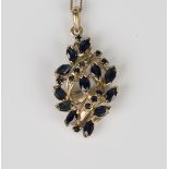 A 9ct gold and sapphire pendant of drop shaped design, mounted with marquise shaped and circular cut