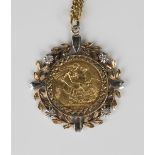 An Elizabeth II sovereign 1974 in a diamond set floral and foliate decorated pendant mount, length