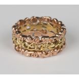 A Clogau 9ct two colour gold band ring in a pierced scrolling and foliate triple band design, ring
