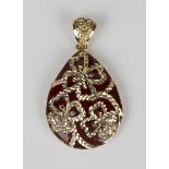 A gold and red glass drop shaped pendant, the front with three quatrefoil motifs, detailed '585',