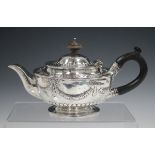 A Victorian silver teapot of circular form, decorated in relief with festoons, London 1843 by