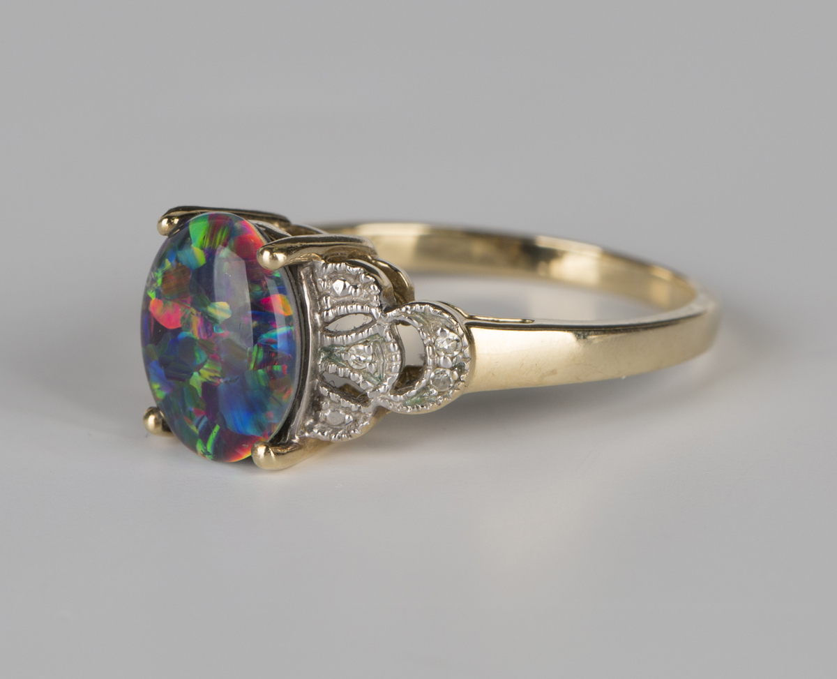 A 9ct gold ring, claw set with an oval opal triplet between diamond set pierced shoulders, - Image 5 of 6