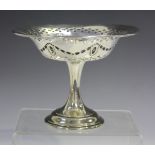 An Edwardian silver bonbon tazza, the circular top with embossed bellflower festoon and pierced