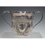 A George III silver porringer, the slightly flared half-reeded body with scroll framed vacant oval