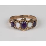 A gold ring, mounted with three oval cut amethysts alternating with two oval opals, detailed '9c',