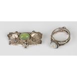 A silver and dyed pale green chalcedony brooch in an Arts and Crafts inspired foliate and beaded