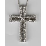 An 18ct white gold and diamond pendant cross, claw set with the principal circular cut diamond to