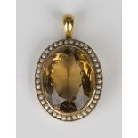 A gold, citrine and seed pearl pendant, mounted with the oval cut citrine within a surround of