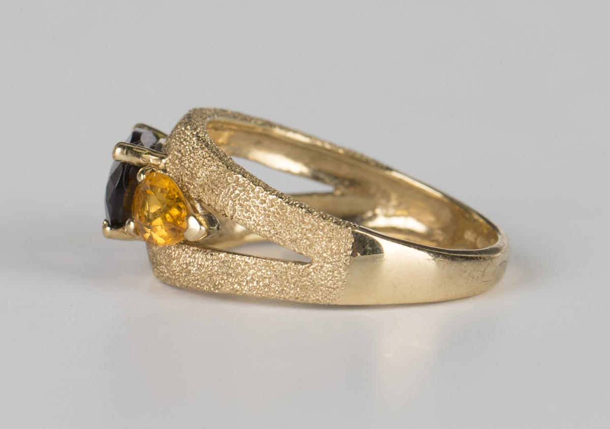 A 9ct gold ring, claw set with an oval cut smoky quartz between two pear shaped citrines, - Image 3 of 4