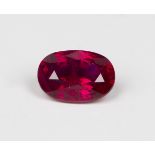 An unmounted Burmese cushion shaped oval ruby, carat weight approx 1.5ct, with accompanying Gem &