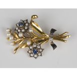 A 9ct two colour gold, sapphire, rose cut diamond and seed pearl brooch, designed as a spray of