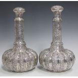 A pair of Cambodian silver bottles and stoppers, late 19th/early 20th century, each lobed pumpkin