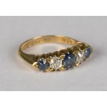 A late Victorian 18ct gold, sapphire and diamond five stone ring, claw set with three cushion shaped