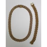 A 9ct gold multiple row oval link necklace with snap clasp, London 1990, length 44cm, and a matching