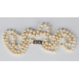 A two row necklace of graduated cultured pearls on a diamond set rectangular clasp, total length
