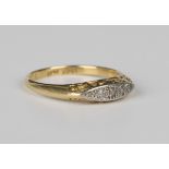 A gold, platinum and diamond ring, mounted with a row of variously cut diamonds in a boat shaped