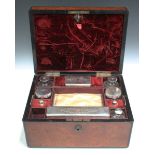 A Victorian walnut cased travelling vanity box, the compartmentalized interior fitted with three