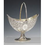 A Victorian silver oval bonbon basket, decorated with foliate scrolls and oval cartouches, with