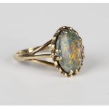 A 9ct gold ring, claw set with an oval opal triplet between split shoulders, ring size approx O1/