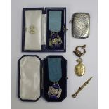 An Edwardian silver rectangular vesta case, Birmingham 1906, two silver and blue enamelled medals,