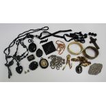 A group of Victorian and later mourning and other jewellery, comprising five pendants and lockets, a
