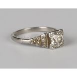 A diamond ring, mounted with the principal cushion shaped diamond between diamond three tier stepped