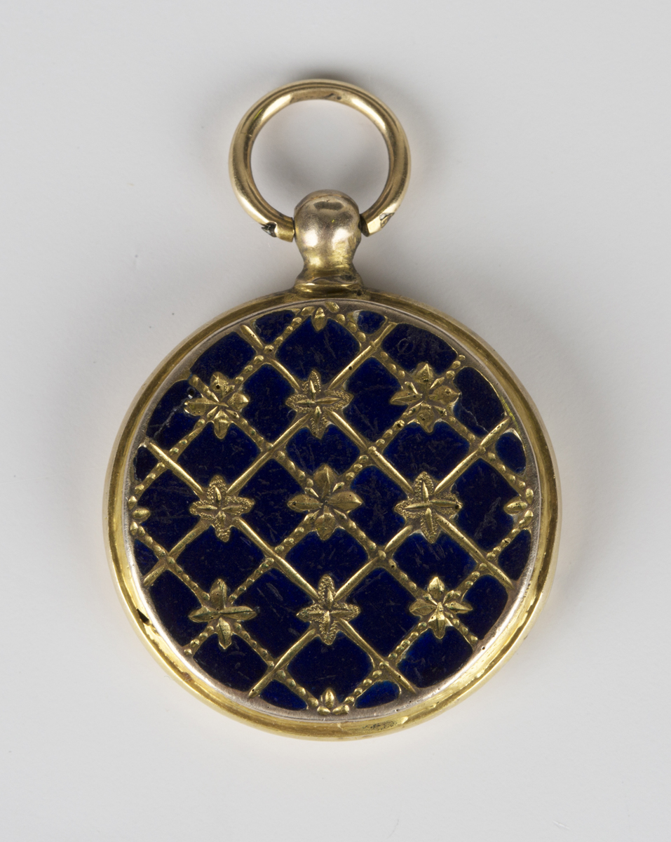 A Victorian blue enamelled circular pendant locket, the front with floral decoration on a cross-
