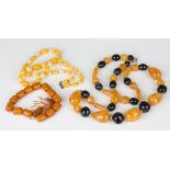 A single row necklace of graduated agate beads, a carved mother-of-pearl necklace, formed as a row
