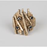 A 9ct gold and sapphire ring, the bark textured front set with four circular cut sapphires,