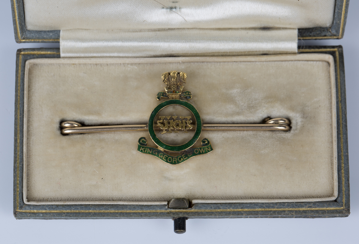 A gold and green enamelled Indian Army military bar brooch, designed as the badge of the XIV
