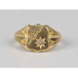 An 18ct gold and diamond shield shaped signet style ring, star set with a circular cut diamond,