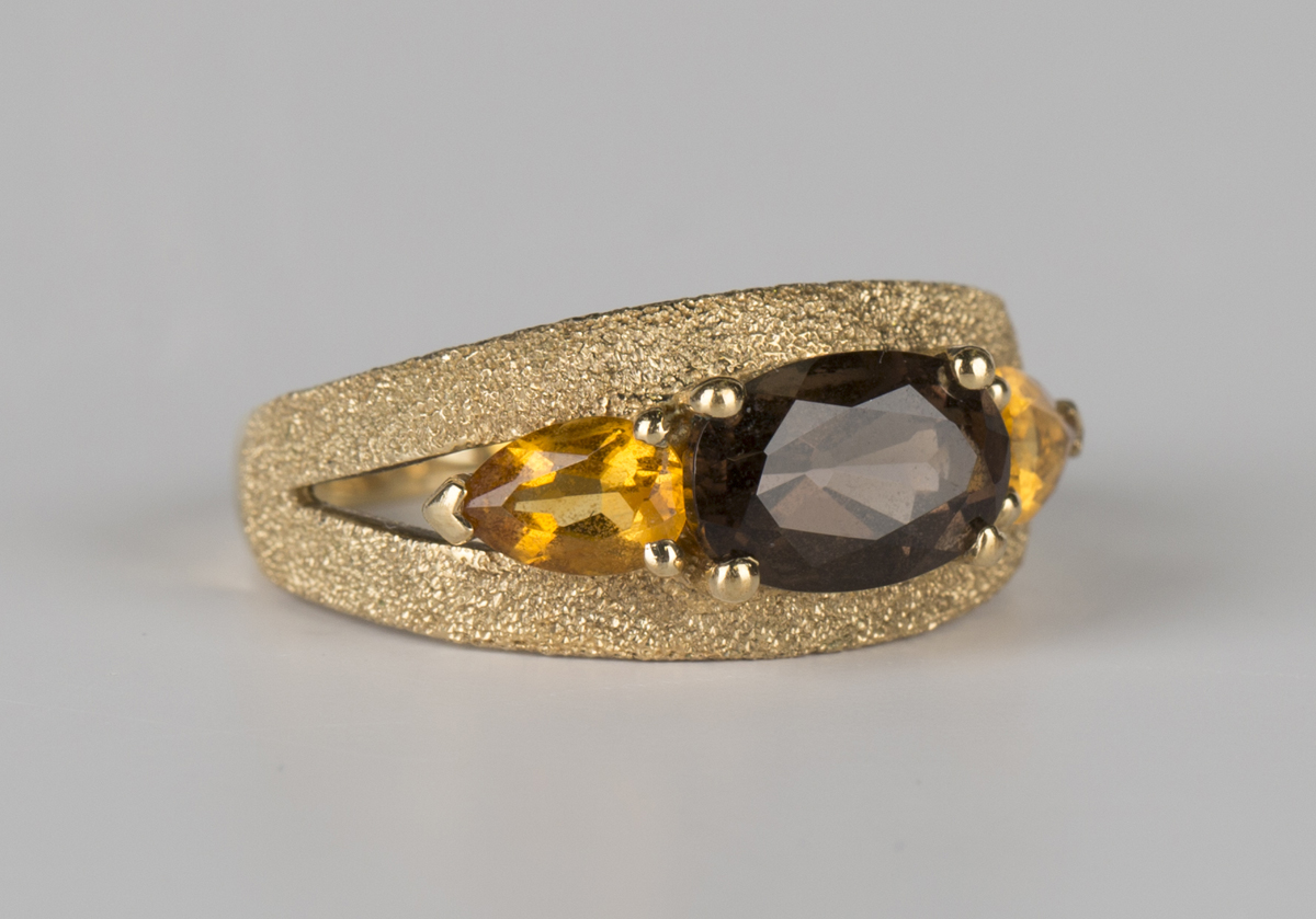 A 9ct gold ring, claw set with an oval cut smoky quartz between two pear shaped citrines, - Image 2 of 4