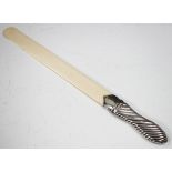 A Victorian silver handled page turner with ivory blade, the handle with wrythen reeded