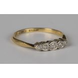 A gold and platinum diamond five stone ring, mounted with a row of graduated circular cut