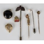 A Bohemian garnet stickpin, a gold topped and diamond set single stone stickpin, detailed '15',