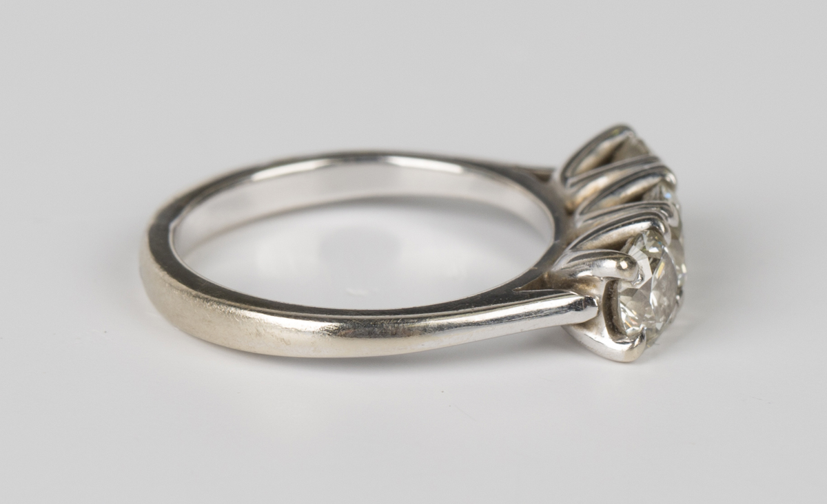 An 18ct white gold and diamond three stone ring, claw set with a row of circular cut diamonds, - Image 3 of 3