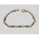 A gold bracelet in a pierced tapered bar and circular link design, indistinctly detailed '9c', on