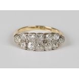 A gold, platinum and diamond ring in a two row boat shaped design, mounted with cushion cut