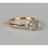 A gold, platinum and diamond seven stone cluster ring in a flowerhead shaped design, detailed '