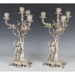 A pair of late 19th/early 20th century Russian silver four-light, three-branch candelabra, 84