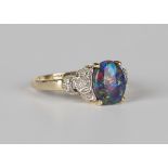 A 9ct gold ring, claw set with an oval opal triplet between diamond set pierced shoulders,