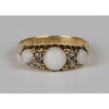 A late Victorian 18ct gold ring, mounted with three opals alternating with two pairs of rose cut